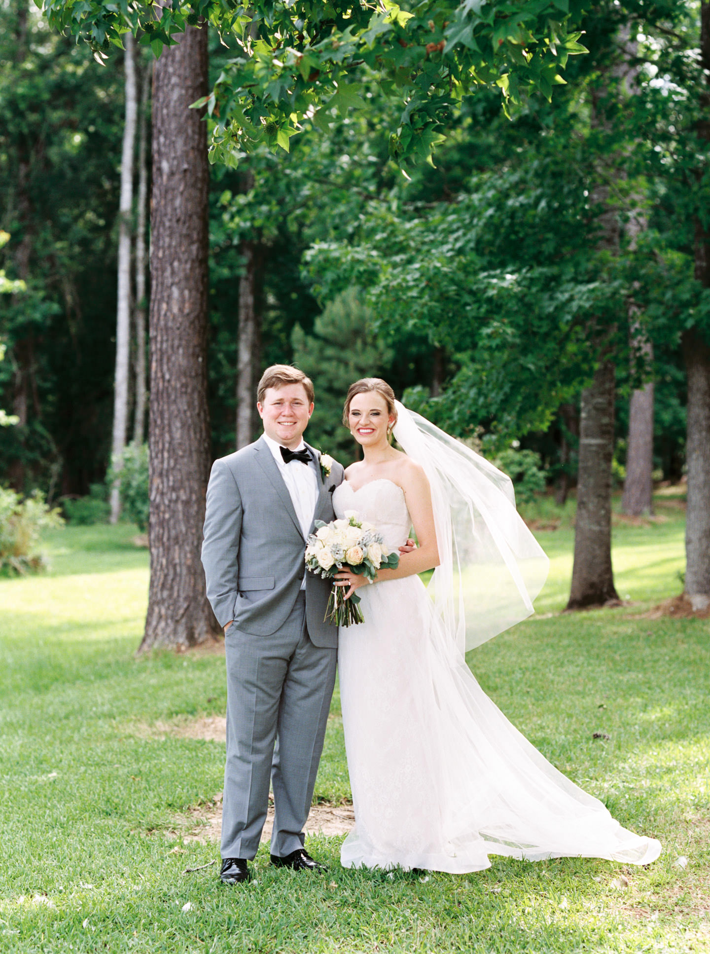 Mississippi Bride and Groom smile for an outdoor film portrait for fine art wedding photographer Ashley Schurch