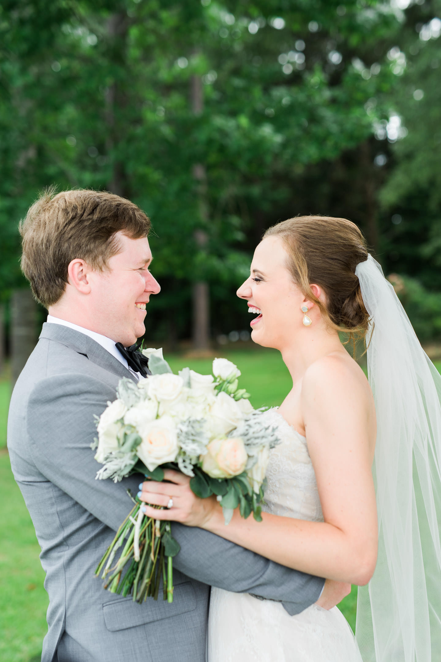 Bride and Groom laughing at each other following Mississippi wedding ceremony