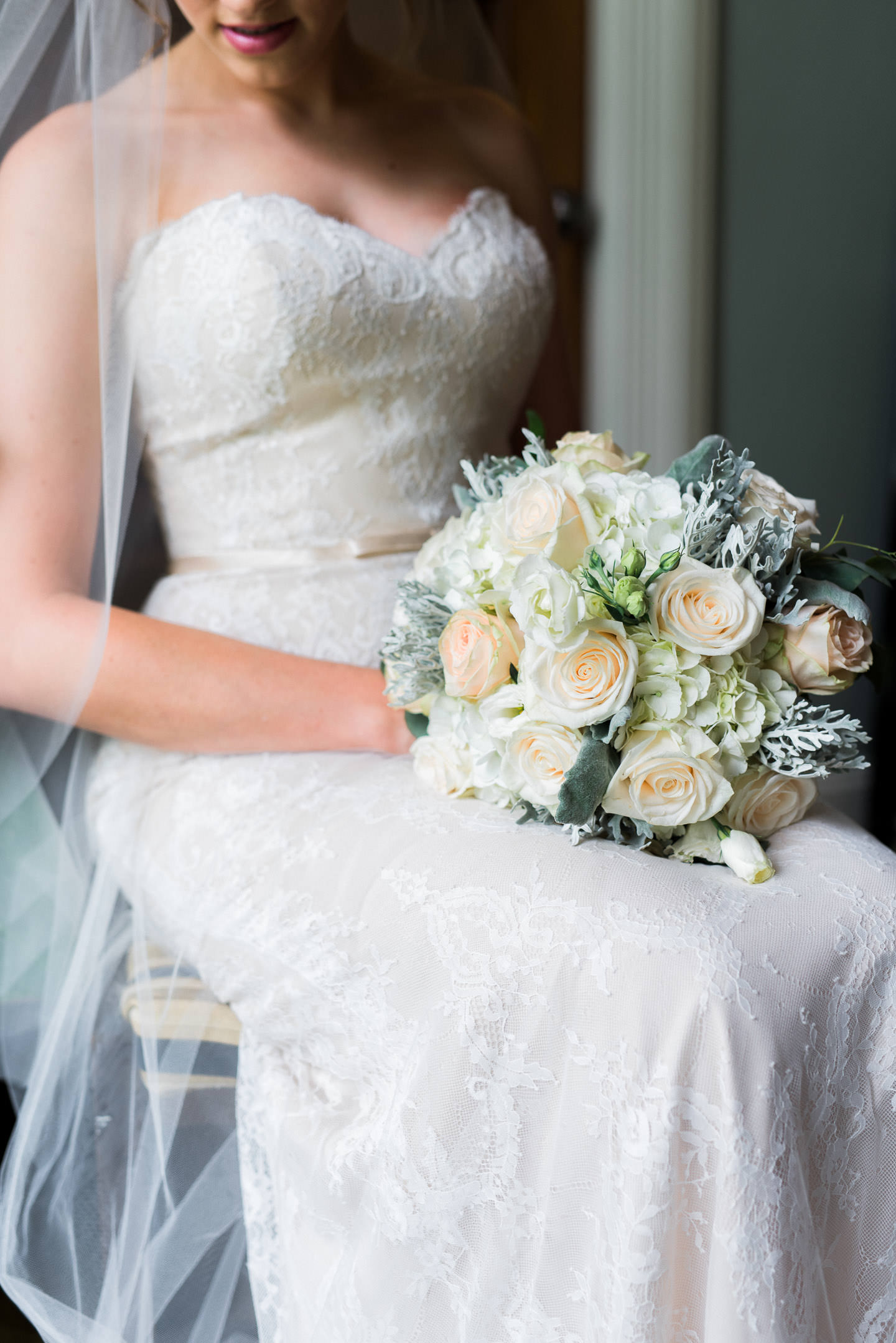 Fine Art portrait of bride's bouquet, dress, and veil, while sitting inside Mississippi's best wedding venue