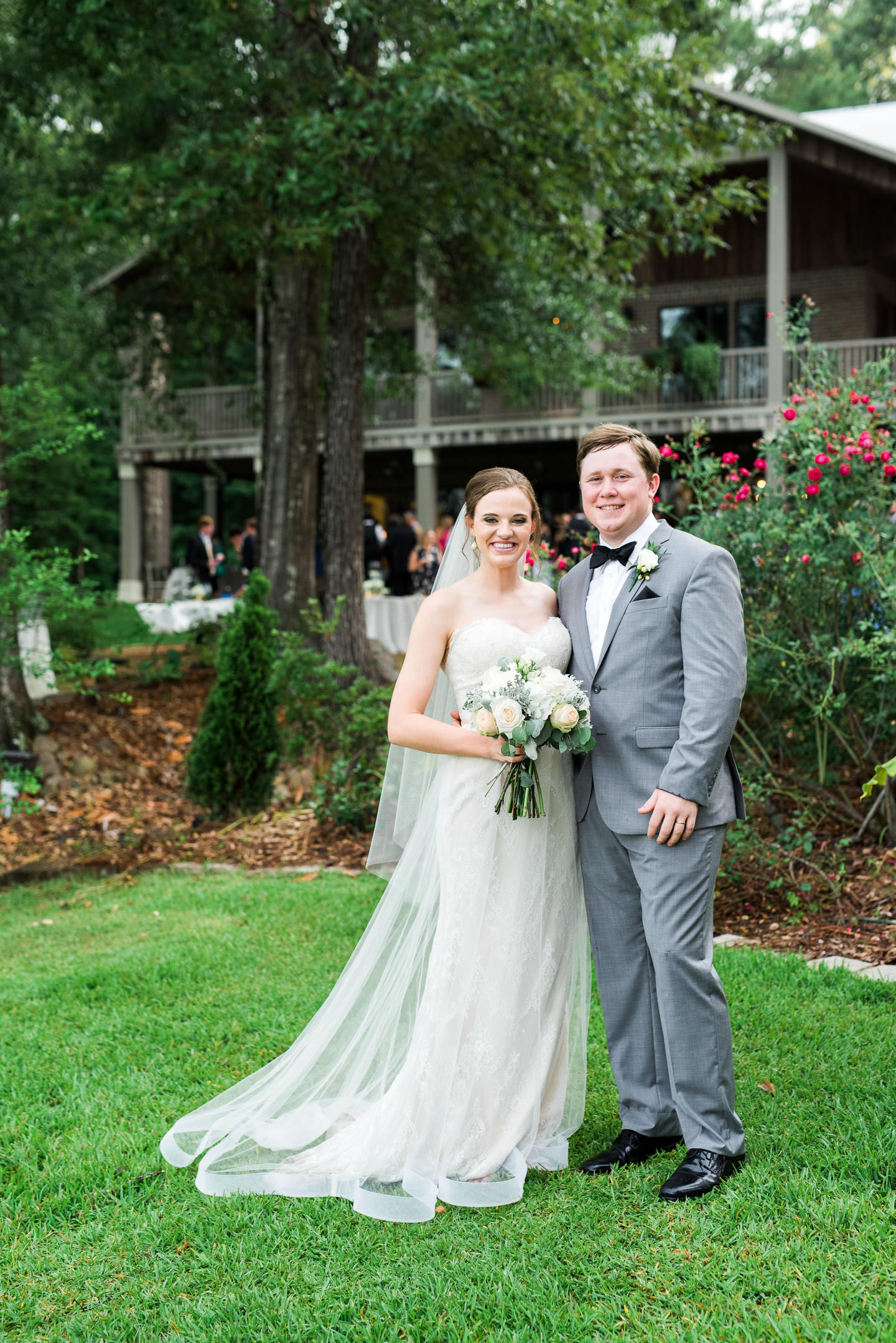Jackson, Mississippi bride and groom smile for a portrait following their outdoor southern wedding