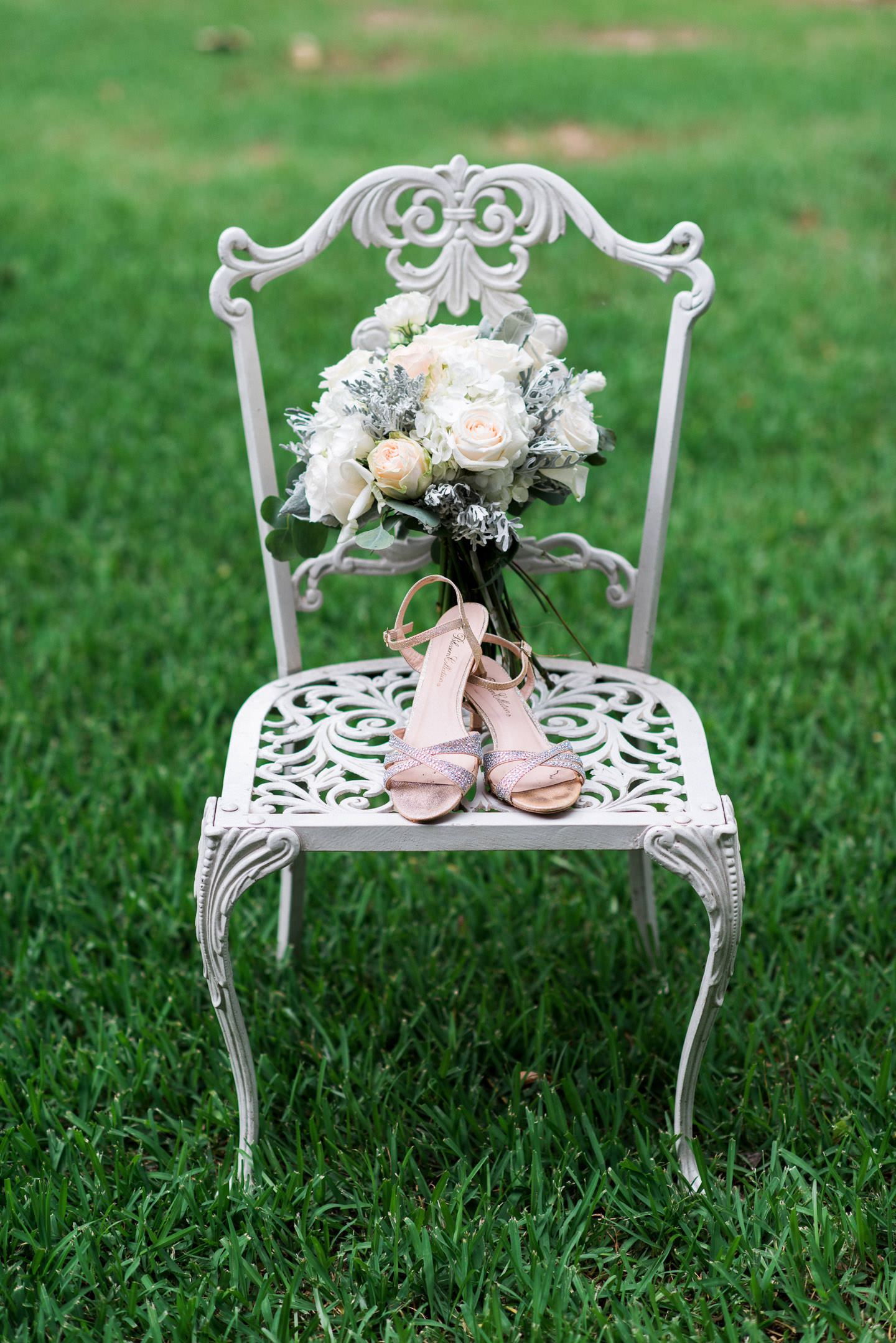 Bride's shoes and bouquet on white chair at Jackson, Mississippi wedding